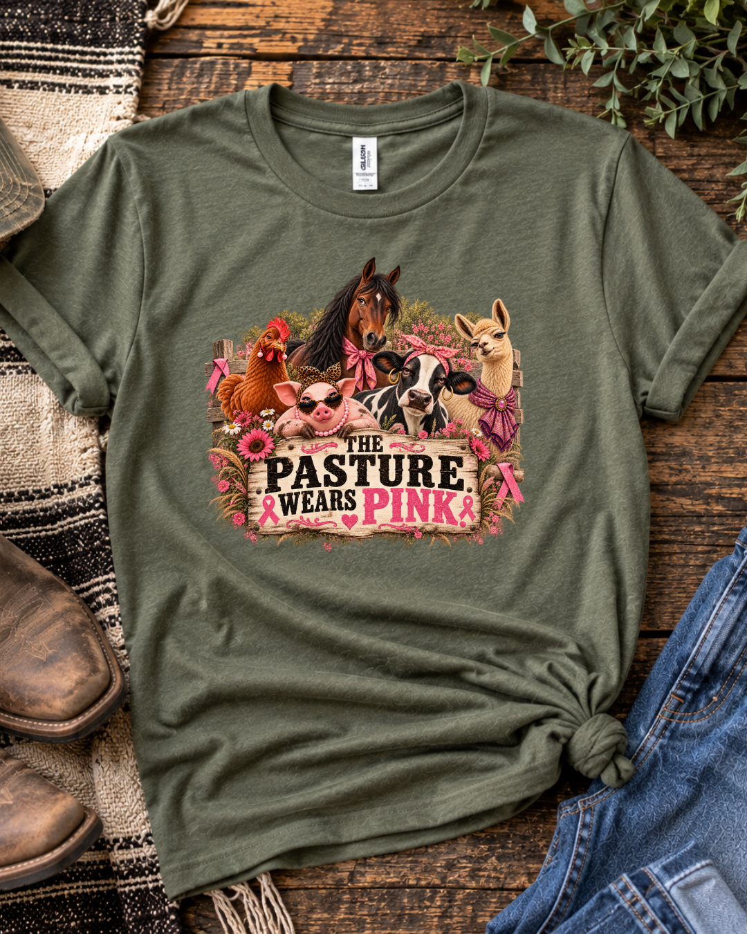 Olive green Pasture Wears Pink breast cancer awareness T-shirt featuring the farm-animal herd and pink lettering on a rustic background.