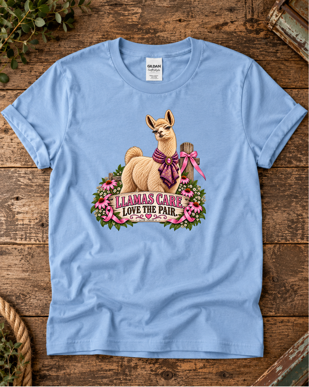 Light blue Llamas Care Love the Pair breast cancer awareness T-shirt featuring Blanche the llama with a pink ribbon and flowers.